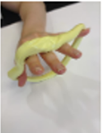 long sausage of putty is wrapped in a loop around all the the fingers and moves as the child stretches their fingers out